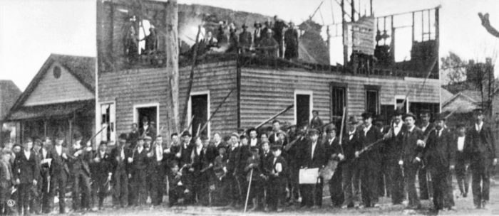 The Wilmington massacre of 1898 was actually a coup d'état, in which a mob of 2,000 white supremacists overturned a biracial city government, burned black homes and businesses like the Black-owned Daily Record pictured above, and murdered hundreds of people. This is recounted in Four Threats.